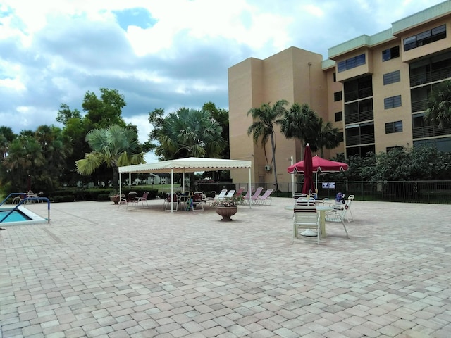 view of property's community featuring a patio and fence