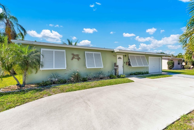 ranch-style house with an attached garage, driveway, and stucco siding