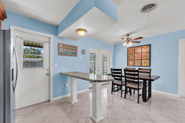 dining space featuring plenty of natural light, french doors, visible vents, and light tile patterned flooring