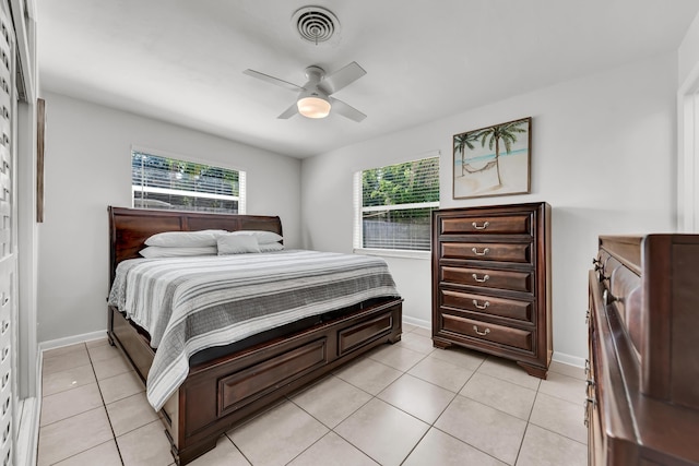 bedroom featuring visible vents, multiple windows, baseboards, and light tile patterned flooring