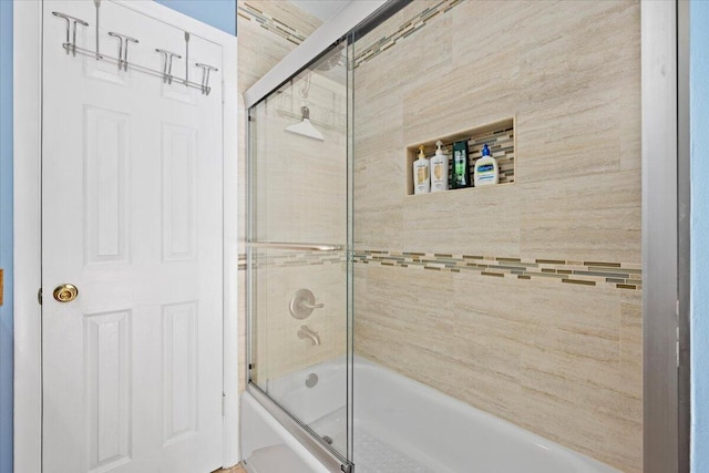 bathroom featuring shower / bath combination with glass door