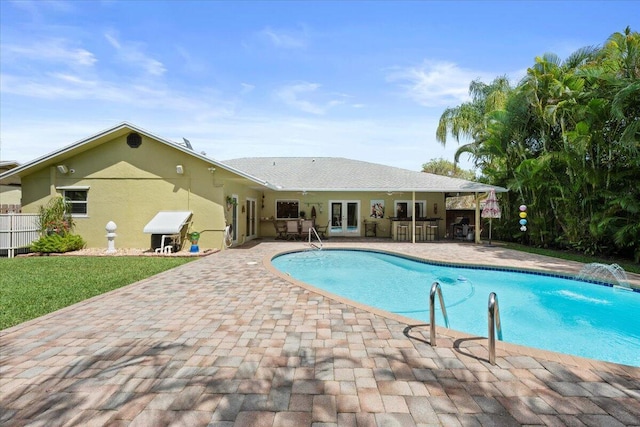 pool featuring french doors, a patio, and fence