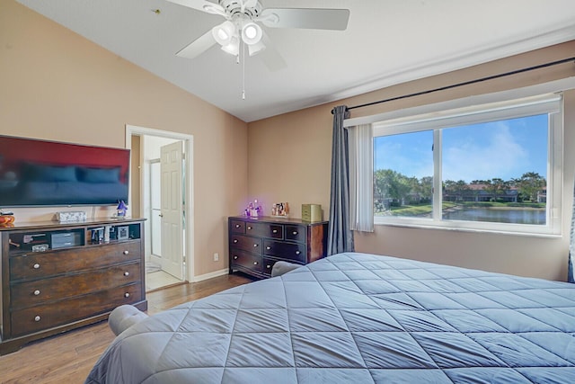 bedroom with ceiling fan, baseboards, lofted ceiling, and wood finished floors