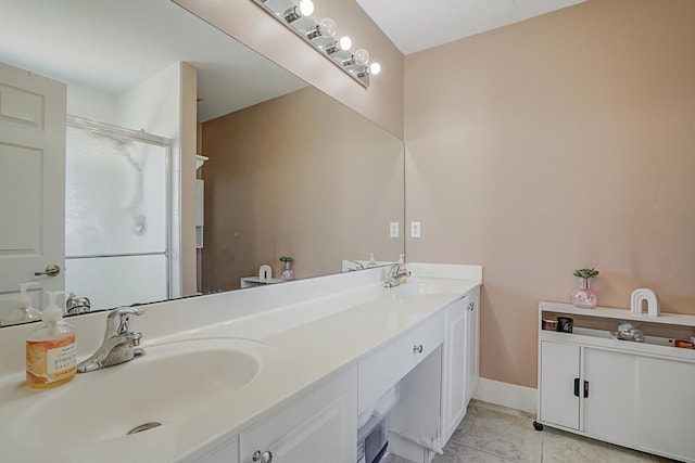 bathroom featuring a sink, double vanity, a shower stall, and tile patterned flooring