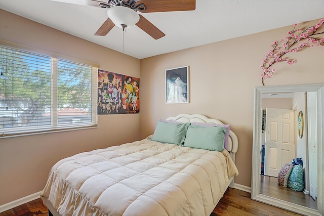 bedroom featuring ceiling fan, baseboards, and wood finished floors