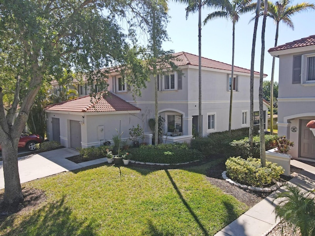 view of front of house with a garage, concrete driveway, stucco siding, and a tile roof