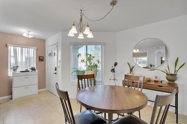 dining space with light tile patterned floors, a notable chandelier, and a healthy amount of sunlight