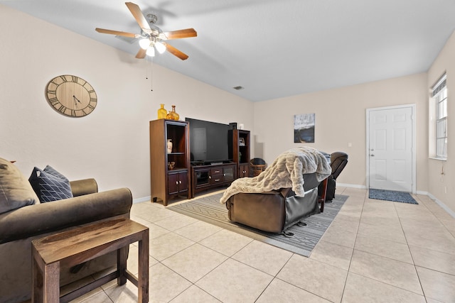 living room with light tile patterned floors, a ceiling fan, and baseboards