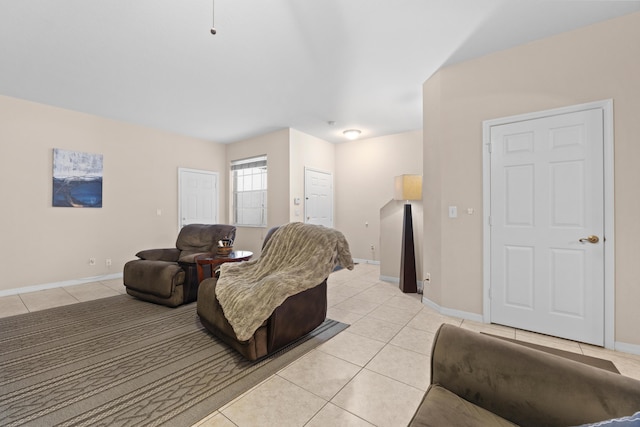 living area featuring baseboards and light tile patterned flooring