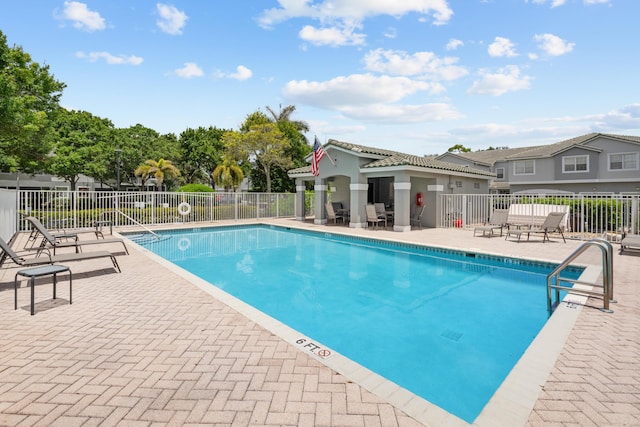 pool featuring a patio area and fence