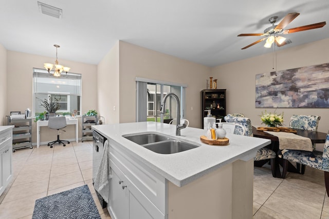 kitchen with visible vents, light countertops, light tile patterned floors, dishwashing machine, and a sink