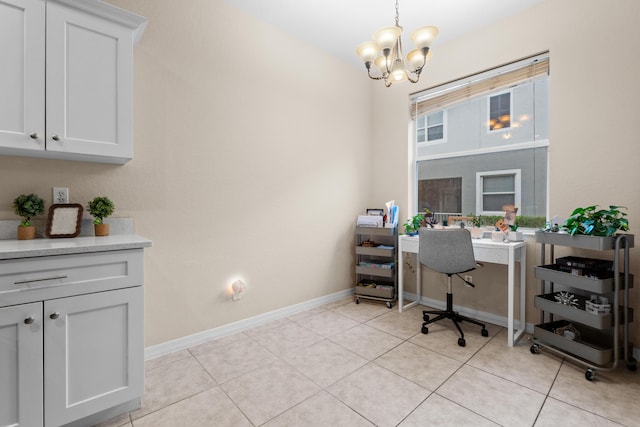 office area with light tile patterned floors, baseboards, and an inviting chandelier