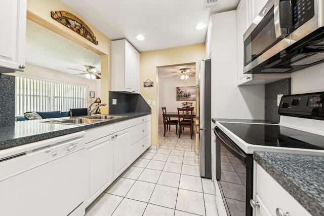 kitchen featuring a sink, appliances with stainless steel finishes, ceiling fan, and white cabinets