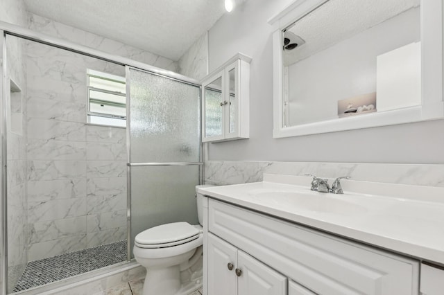 full bath featuring toilet, marble finish floor, a textured ceiling, a shower stall, and vanity