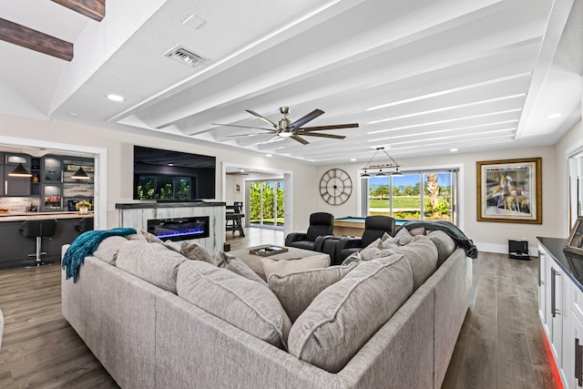 living area featuring beamed ceiling, visible vents, and dark wood-style flooring