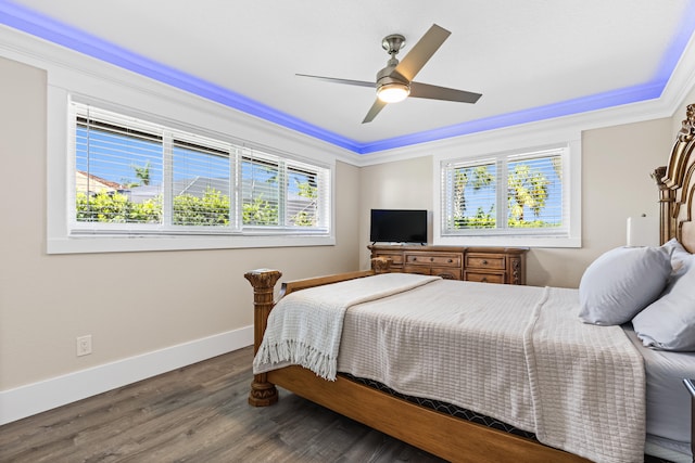 bedroom featuring ornamental molding, ceiling fan, baseboards, and wood finished floors