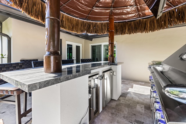 view of patio / terrace with beverage cooler, area for grilling, and french doors