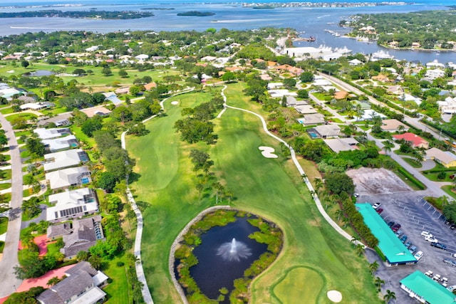 aerial view with a residential view, view of golf course, and a water view