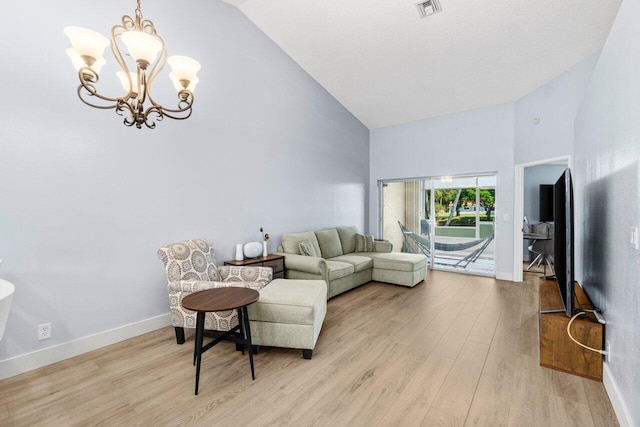 living room with visible vents, high vaulted ceiling, an inviting chandelier, and light wood finished floors