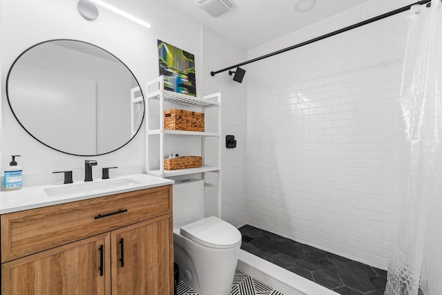 full bathroom with a tile shower, visible vents, and toilet