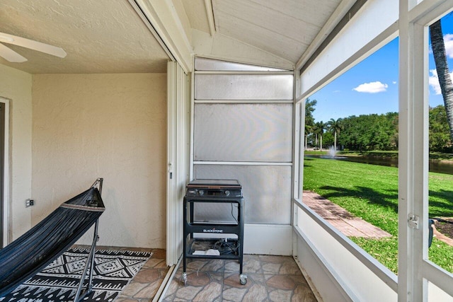 sunroom / solarium featuring lofted ceiling and ceiling fan