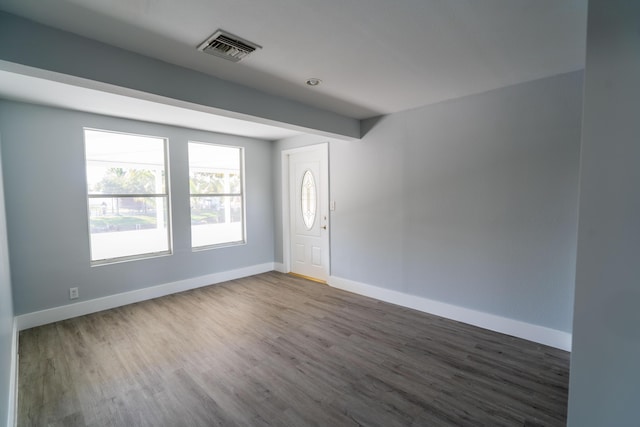 unfurnished room with visible vents, baseboards, and wood finished floors