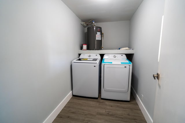 laundry room featuring electric water heater, baseboards, laundry area, wood finished floors, and separate washer and dryer