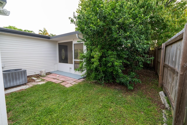 view of yard featuring central AC unit and a fenced backyard