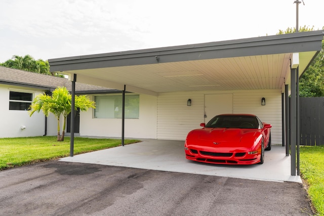 view of parking with aphalt driveway and an attached carport