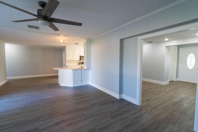 unfurnished living room with a ceiling fan, baseboards, visible vents, dark wood finished floors, and ornamental molding