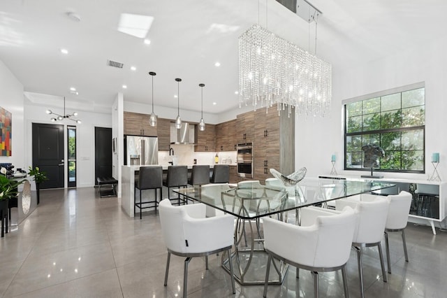 dining room featuring visible vents, recessed lighting, a high ceiling, and an inviting chandelier