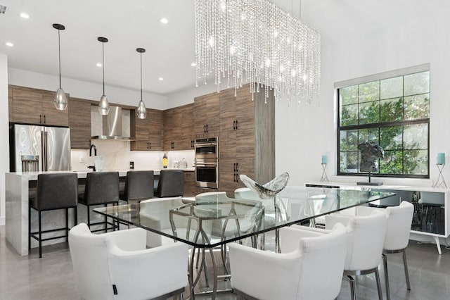 dining space featuring visible vents, recessed lighting, an inviting chandelier, and a towering ceiling