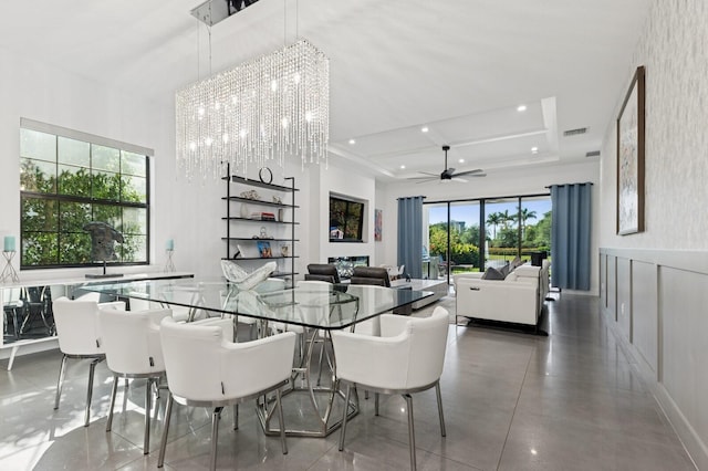 dining area with visible vents, a wainscoted wall, recessed lighting, ceiling fan with notable chandelier, and a decorative wall