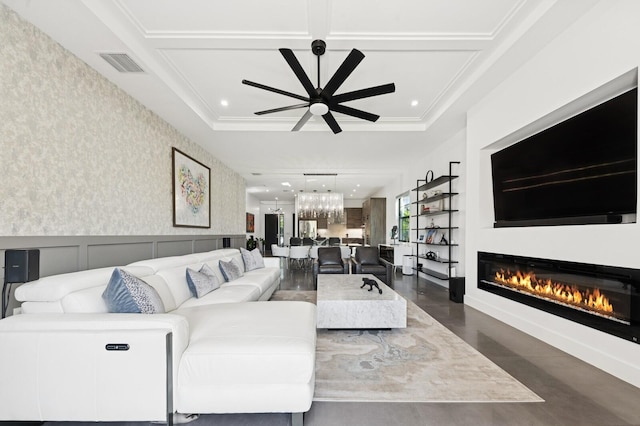 living area with a wainscoted wall, visible vents, a ceiling fan, a glass covered fireplace, and wallpapered walls