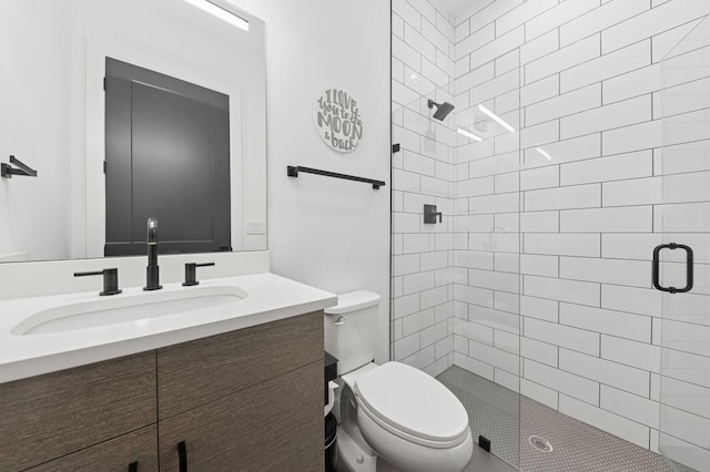 full bath featuring a stall shower, toilet, and vanity