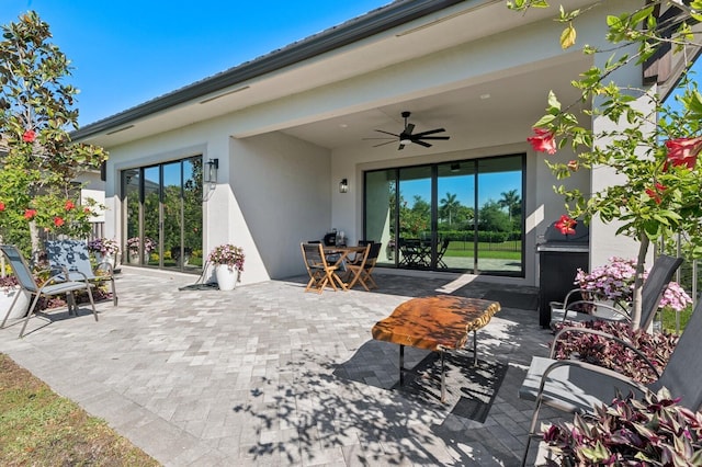 view of patio / terrace with outdoor dining area and a ceiling fan