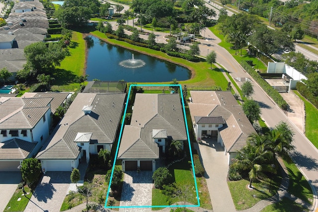 drone / aerial view featuring a water view and a residential view