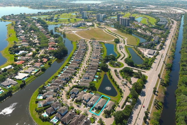 birds eye view of property with a water view and a residential view