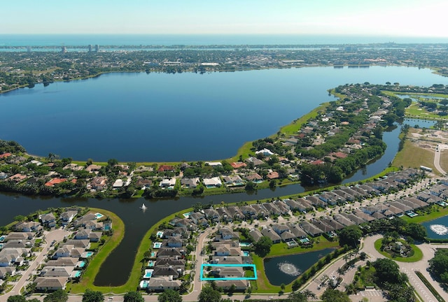 drone / aerial view with a residential view and a water view