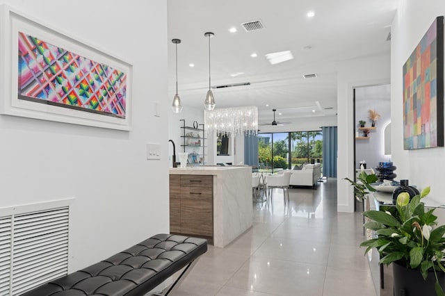 hall featuring light tile patterned flooring, recessed lighting, and visible vents