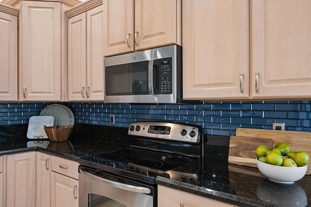 9637 Spray Dr, West Palm Beach, FL 33411 - kitchen with appliances with stainless steel finishes, tasteful backsplash, and dark stone counters