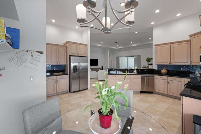 9637 Spray Dr, West Palm Beach, FL 33411 - kitchen with stainless steel appliances, light brown cabinets, tasteful backsplash, a peninsula, and recessed lighting