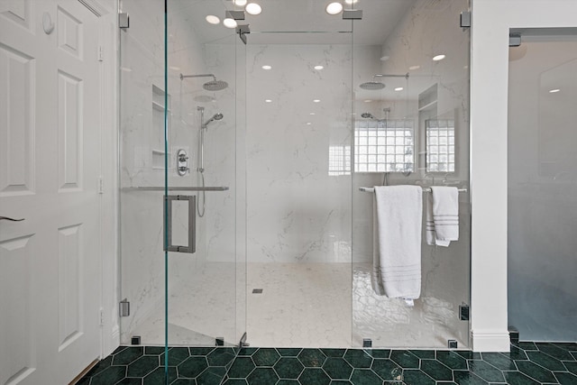 bathroom with a marble finish shower and tile patterned floors
