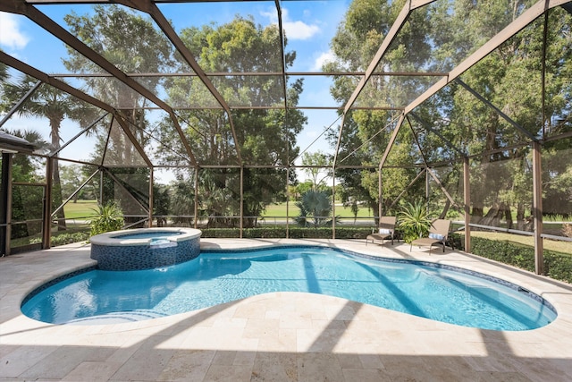 view of swimming pool with a patio, glass enclosure, and a pool with connected hot tub
