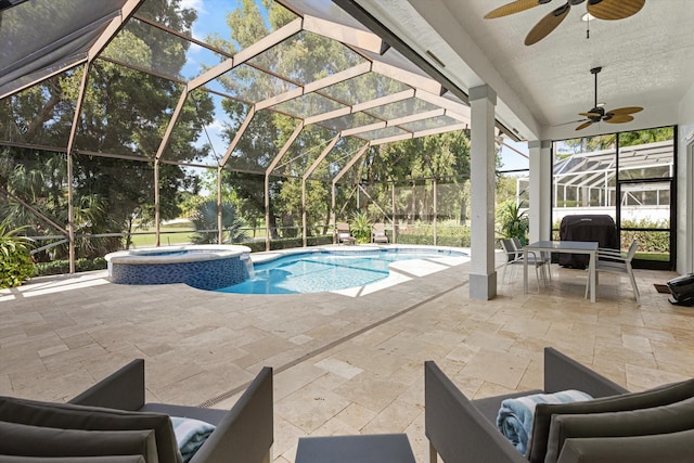 view of swimming pool with a ceiling fan, a patio area, and a lanai