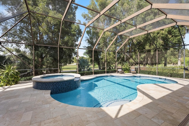 view of pool with a lanai, a patio, and a pool with connected hot tub