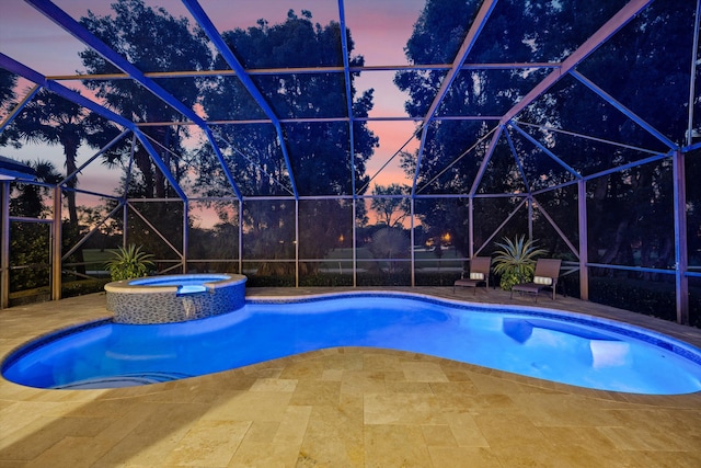 view of pool featuring a lanai, a patio, and a pool with connected hot tub