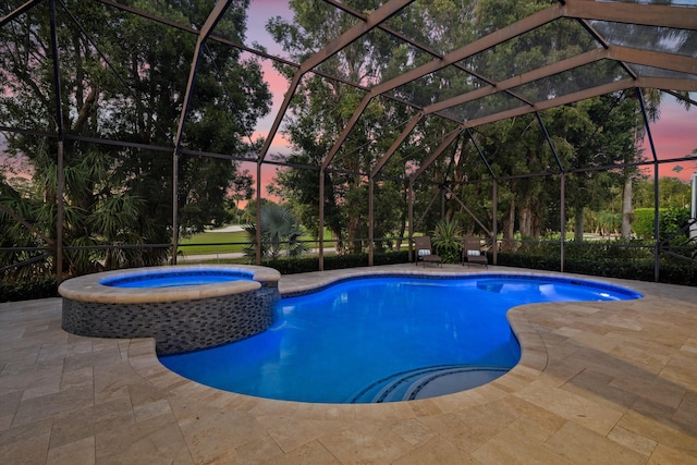 pool at dusk featuring a patio, glass enclosure, and a pool with connected hot tub