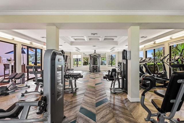 gym featuring crown molding, a wealth of natural light, and coffered ceiling