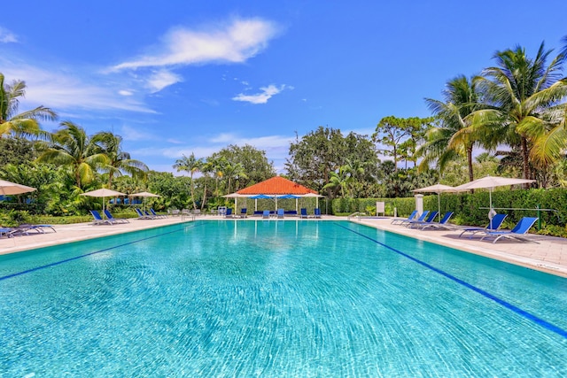 pool with fence and a patio area